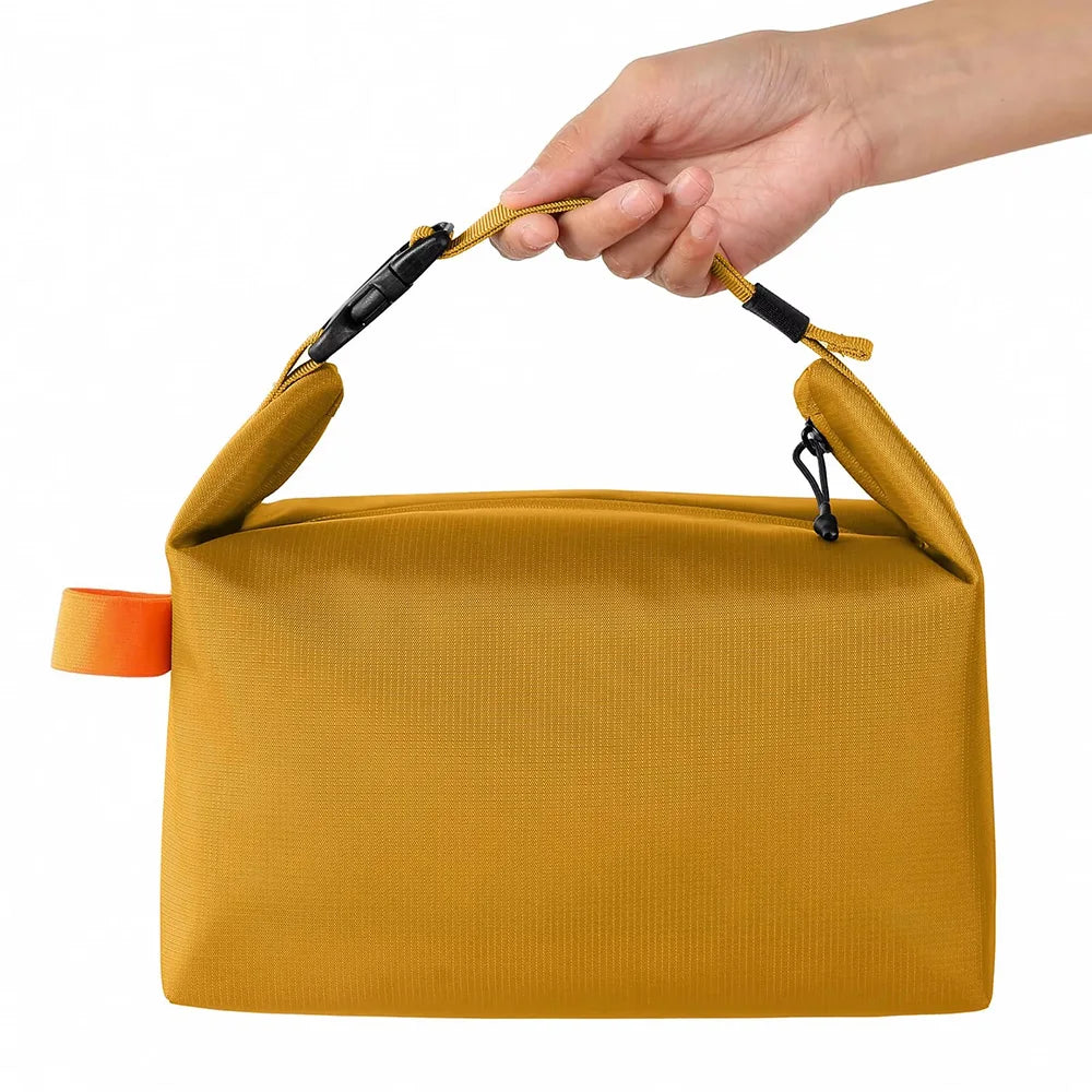 Yellow pouch with an orange tag held by a hand on a white background