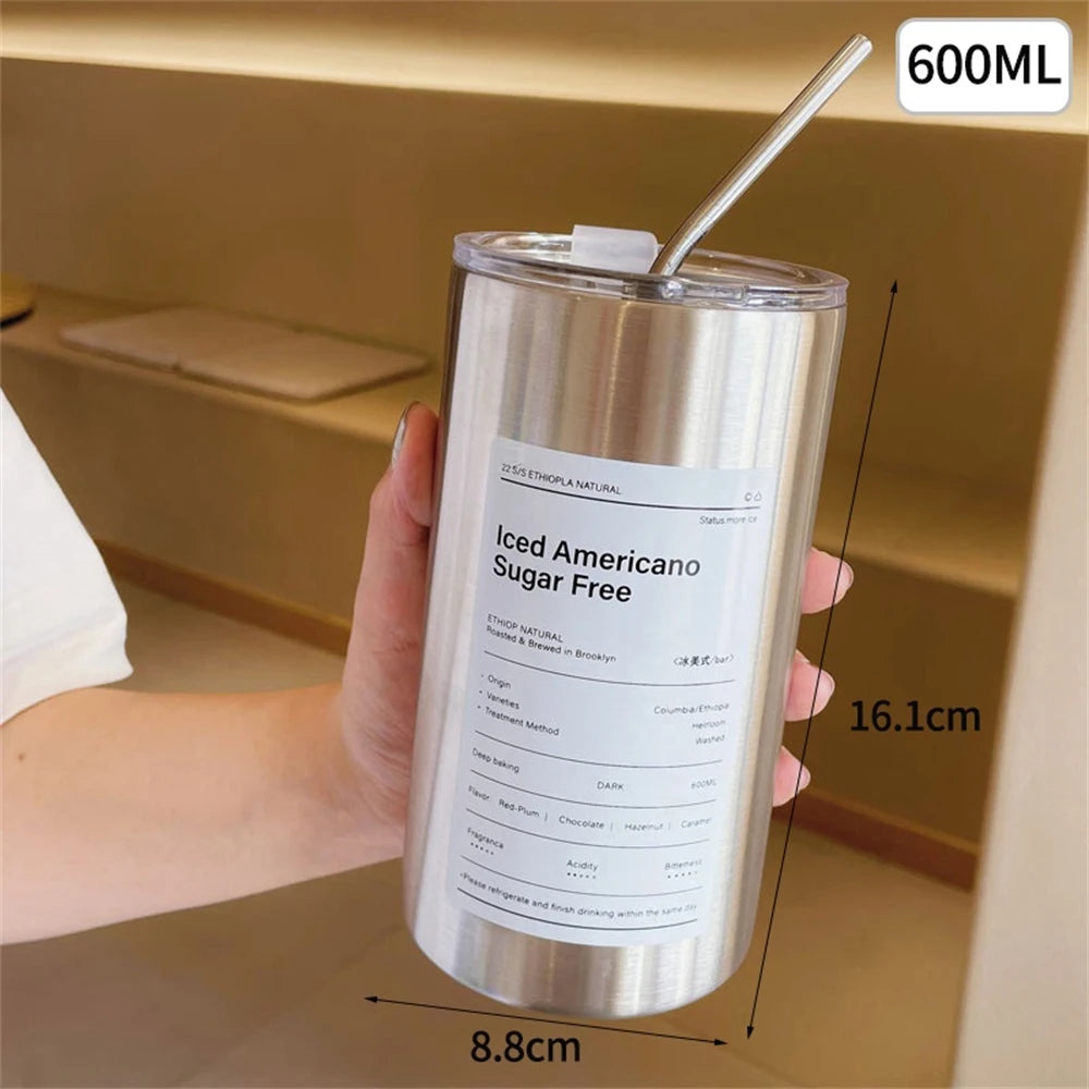 Stainless steel tumbler with a label on a neutral background
