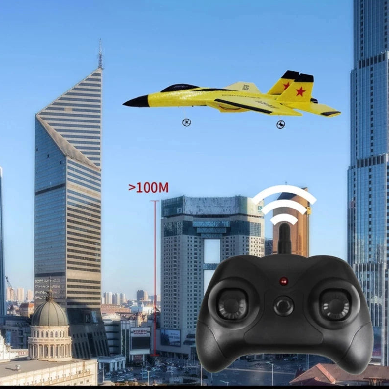 Yellow and black remote control airplane flying over a cityscape with a controller in the foreground.