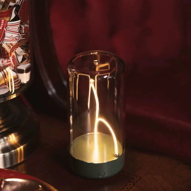 Glass container with a glowing interior on a wooden surface